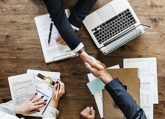 Handshake over papers